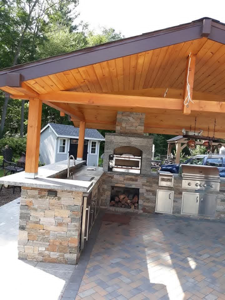 Wood pavilion with outdoor kitchen and stone counter