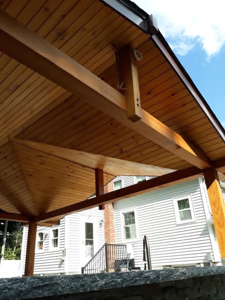 Cedar pavilion frame beside a house
