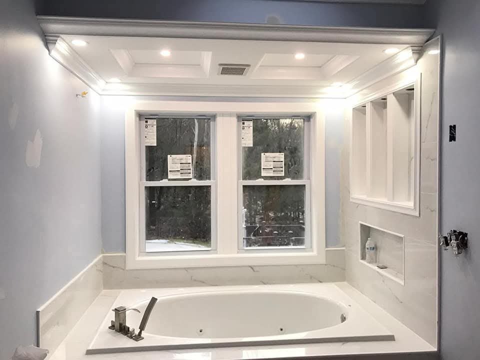 Bathroom with soaking tub under a double window