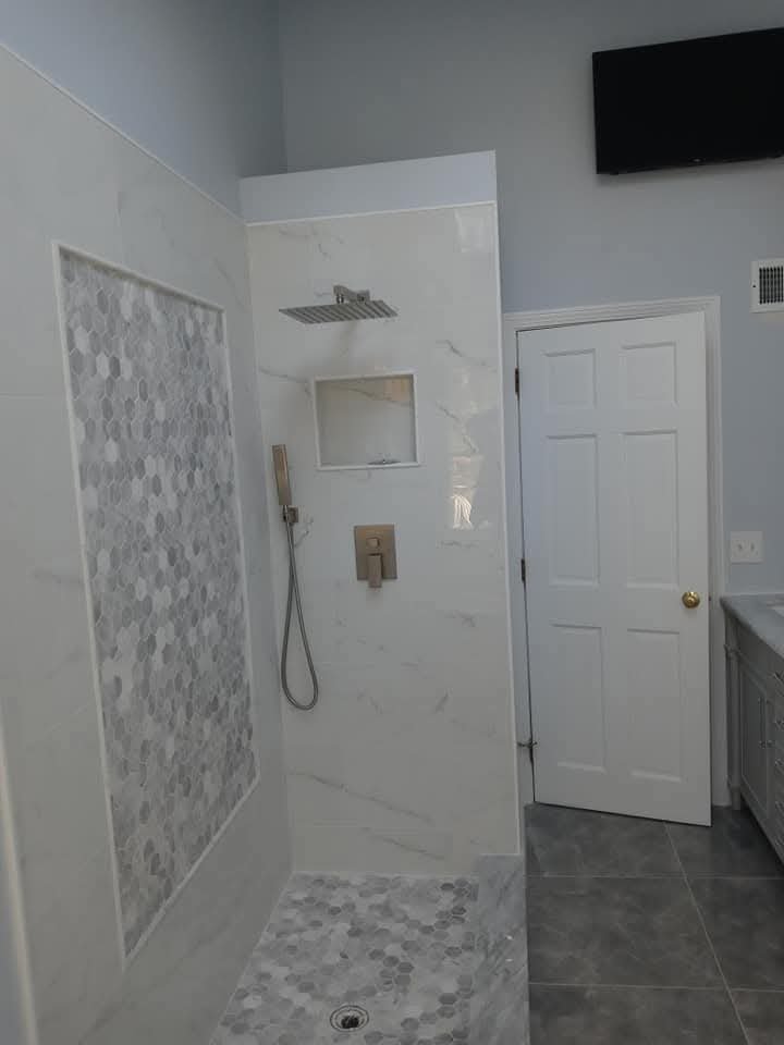 Walk-in shower with decorative tile and rain shower head