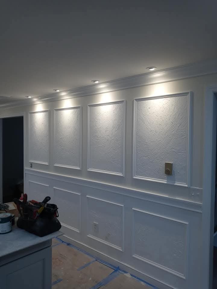 Custom paneled wall with recessed lighting