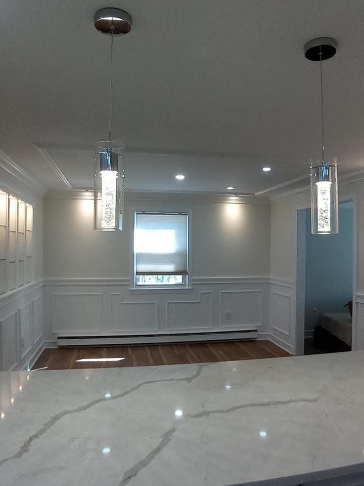 Kitchen with pendant lights and wainscoting
